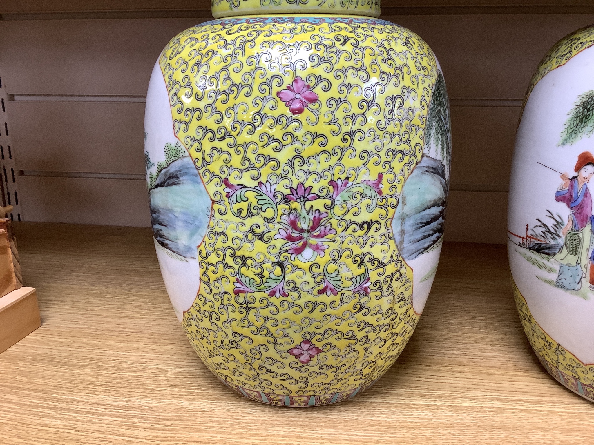 A pair of Chinese yellow ground vases and covers, height 30cm